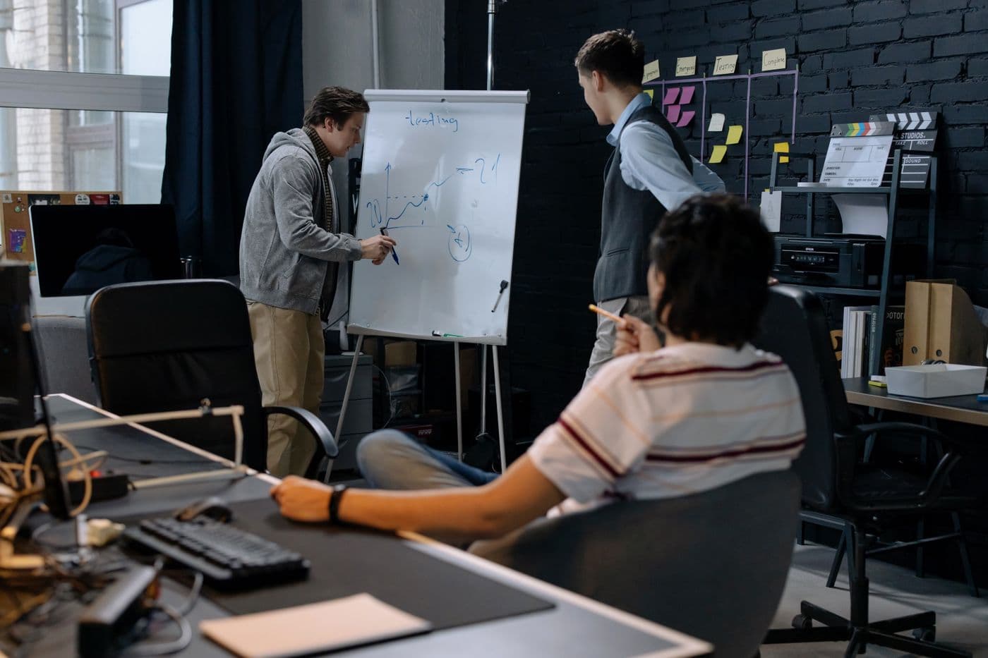 A team discussing a design at a whiteboard